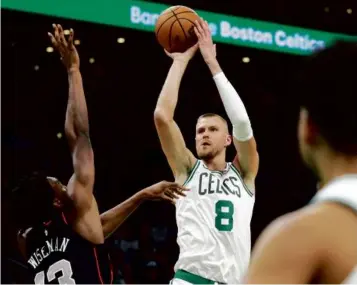  ?? DANIELLE PARHIZKARA­N/GLOBE STAFF ?? Kristaps Porzingis scored 20 points and grabbed 8 rebounds in 21 minutes Monday night against the Pistons in his return from a right hamstring strain.