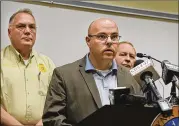  ?? BOBBY HAVEN / THE BRUNSWICK NEWS ?? Glynn County Police Department Chief of Staff Brian Scott addresses members of the media as County Police Chief John Powell (left) and Glynn County Sheriff Neal Jump join him June 29.