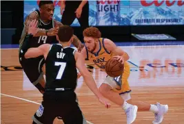  ?? RANDALL BENTON/AP ?? Kings guards Daquan Jeffries (19) and Kyle Guy (7) defend against Golden State Warriors guard Nico Mannion (2) during the first quarter Thursday in Sacramento, Calif.