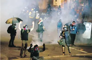  ?? THE OREGONIAN VIA AP ?? Demonstrat­ors and police clash in downtown Portland early Thursday. Oregon’s largest city has been the target of months of protests following the death of George Floyd, the Black man who died after being pinned by the neck by a white Minneapoli­s police officer.