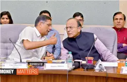  ?? — PTI ?? Finance minister Arun Jaitley listens to CEA Arvind Subramania­n during an event for the signing of MoU between Department of Economic Affairs and NBCC ( India) Ltd. for constructi­on of housing project for IES officers in New Delhi on Friday.