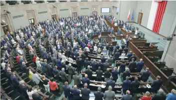  ?? — Reuters ?? Members of Poland’s lower house of parliament attend the first reading of a bill introduced by the ruling Law and Justice (PiS) party that calls for an overhaul of the Supreme Court in Warsaw on Tuesday.