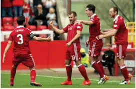  ??  ?? NIALL NAILS IT: McGinn (second left) is the centre of attention after his opener