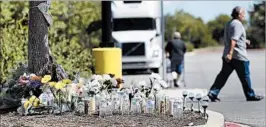  ?? ERIC GAY/AP ?? A memorial sits in a TexasWamar­t parking lot where authoritie­s found a tractor-trailer packed with immigrants.