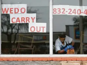  ?? Godofredo A. Vásquez / Staff photograph­er ?? Enrique Torres, co-owner of The Mesquite Grill, wipes down a booth April 6 in the dining room, which holds a maximum of 120 people. Torres and his partners had hoped to get a loan through Harris County’s previous $10 million small business loan fund for the coronaviru­s pandemic.