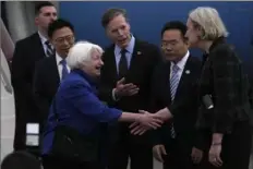  ?? Andy Wong/Associated Press ?? Treasury Secretary Janet Yellen, left, shakes hands with Lisa Heller, U.S. Consul for Guangzhou, on Thursday after arriving at Guangzhou Baiyun Airport in southern China’s Guangdong province.