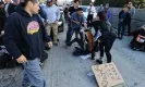  ?? ?? Drivers try to remove protesters blocking traffic on the 110 freeway in Los Angeles, California, on 13 December 2023. Photograph: David Swanson/Reuters