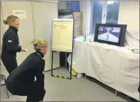  ??  ?? PC Lauren Bradley on controls and Chief Superinten­dent Hazel Hendren taking part in the Wii Challenge.