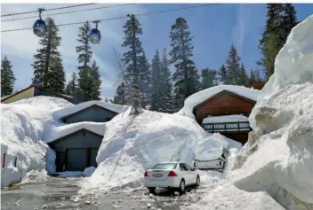  ?? FOTO: BARBARA MUNKER/DPA ?? Rekordschn­eefall hat die Häuser im kalifornis­chen Mammoth Lakes unter einer meterhohen weißen Decke begraben. Doch mit der einsetzend­en Schneeschm­elze werden jetzt Überschwem­mungen erwartet.