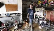  ?? MARK HUMPHREY/ ASSOCIATED PRESS ?? Carson Hollifield, produce manager at the Waverly Cash Saver grocery, slogs through wreckage after employees climbed up on the structure Saturday in an attempt to escape floodwater­s that wrecked the store.