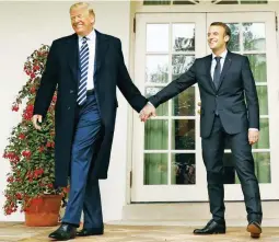  ??  ?? TOP-LEVEL BROMANCE – Presidents Donald Trump of the US and Emmanuel Macron of France hold hands at the White House Tuesday. Reporters without Borders said Trump, China, and Russia form a triple threat to press freedom. (Reuters)