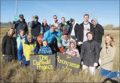  ?? SUBMITTED PHOTO ?? Volunteers pose for a photo Saturday after planting the last of the 15,000 daffodil bulbs planted this year.