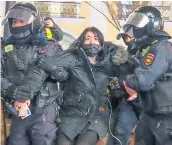  ?? ?? Police officers detain a woman during an anti-war protest in St Petersburg yesterday