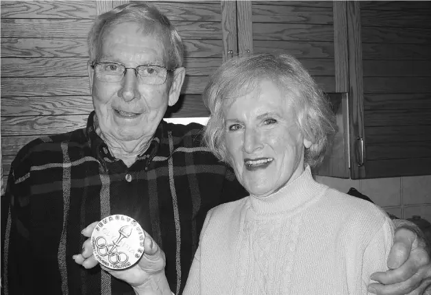  ?? PHOTOS: SUPPLIED ?? Bill Dawe with his wife Lee, who holds his gold medal from the 1952 Winter Olympi cs in Oslo. The hockey team captain rarely talked about his time on the ice.