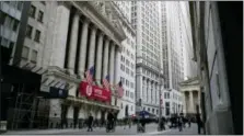  ?? MARY ALTAFFER — THE ASSOCIATED PRESS FILE ?? Pedestrian­s walk past the New York Stock Exchange.