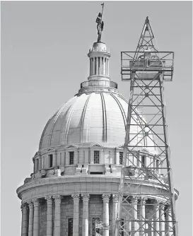  ?? [PHOTO BY JIM BECKEL, THE OKLAHOMAN ARCHIVES] ?? A historic non-working oil derrick is seen at the State Capitol, where oil and gas measures are among the issues lawmakers are considerin­g.