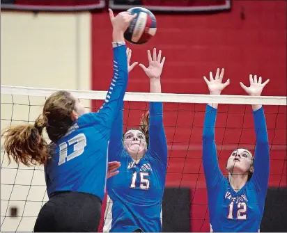  ?? SARAH GORDON/THE DAY ?? In this Nov. 6, 2019, file photo, Waterford’s Liliana Kramer (12) and Sabrina Kobyluck (15) block a shot from Lyman Memorial’s Helen Megson (13) during the Eastern Connecticu­t Conference Division I volleyball tournament semifinals at Fitch High School.