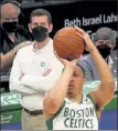  ?? NANCY LANE / BOSTON HERALD FILE ?? Celtics coach Brad Stevens, seen behind Grant Williams as he shoots on Monday night, said he ‘can’t wait’ to get vaccinated so the league can lift restrictio­ns.