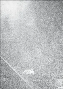  ?? JOHN WOODS THE CANADIAN PRESS ?? A couple sits in the rain as a lightning delay stopped play between the Edmonton Eskimos and the Winnipeg Blue Bombers during the first half of CFL action in Winnipeg Thursday.