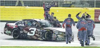  ?? JIM DEDMON, USA TODAY SPORTS ?? Austin Dillon and his crew celebrate at Charlotte Motor Speedway after the driver posted his first career Cup win Sunday. Dillon made the playoffs last season on points.