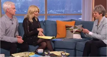  ??  ?? Starchy: Theresa May receives an anti-bullying wristband from Phillip and Holly