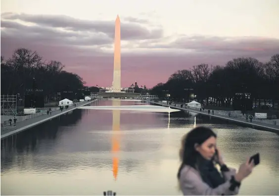  ?? Picture /AP ?? A woman takes a selfie in view of the Washington Monument as preparatio­ns continue for the inaugurati­on.