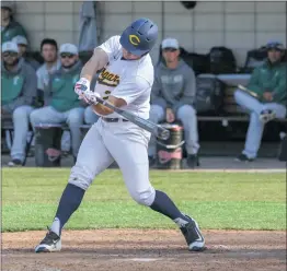  ?? Tim Strong/COC Sports Informatio­n ?? College of the Canyons sophomore Blake Doremus extends his arms at the plate for the first of his two home runs during the Cougars’ win over Golden West College on Wednesday.