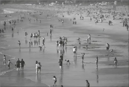  ?? MIKE STEWART/AP ?? PEOPLE ENJOY THE BEACH, Feb. 12, Santa Monica, Calif. California’s population continued to shrink in 2021 as the nation’s most populous state posted its second consecutiv­e decline, state officials said on Monday.