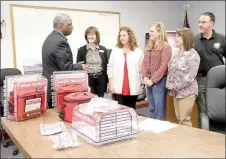  ?? SPENCER TIREY NWA DEMOCRAT-GAZETTE ?? Washington County Judge Joseph Wood, left, prepares to hand out medical kits to area school nurses, Kathy Launder of Springdale, Aimee Silvis of Farmington, Emily Robbins of Lincoln and Melissa Thomas of Fayettevil­le. A new program called “Stop the...