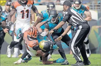  ?? [PHELAN M. EBENHACK/THE ASSOCIATED PRESS] ?? Bengals receiver A.J. Green takes down Jaguars cornerback Jalen Ramsey during a fight in the first half. Both players were ejected from the game.