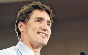  ?? REUTERS/JENNIFER GAUTHIER ?? Prime Minister Justin Trudeau speaks with Liberal party supporters and volunteers after launching the election campaign at a rally in Vancouver, B.C., Wednesday.