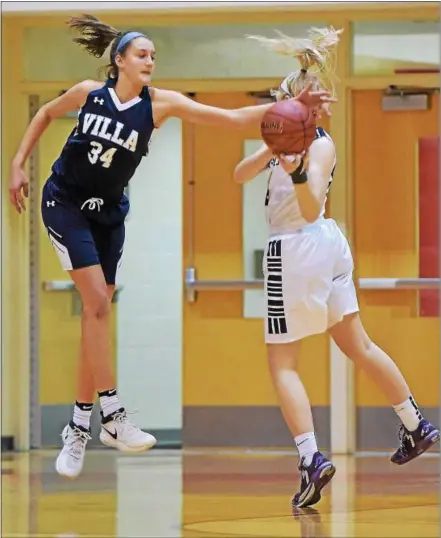  ?? PETE BANNAN — DIGITAL FIRST MEDIA ?? VIlla Maria’s Paige Lauder steals a ball from West Chester Rustin’s Maggie O’Hare in the first quarter of the Hurricanes’ 69-58 victory in the District 1 semifinals Tuesday at Harriton High School.