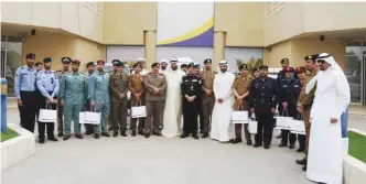  ??  ?? KUWAIT: GCC traffic officials pose outside Kuwait Motoring Company’s building. — Photos by Joseph Shagra