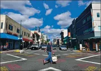  ??  ?? A pedestrian runs in a crosswalk in Chinatown in Oakland. Security has been increased after several assaults on elderly residents and a robbery spree heightened fear in Chinatown.