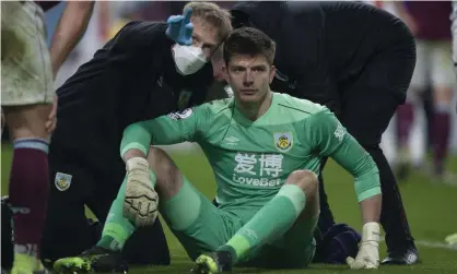  ??  ?? Burnley’s goalkeeper Nick Pope goes through the concussion protocol with medical staff after a blow to the head in Monday’s game with Crystal Palace. Photograph: Jack Phillips/JMP/Shuttersto­ck