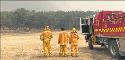  ??  ?? ON THE LOOK OUT: Country Fire Authority District 17 members, from left, Dean Hobbs, Brian Petrass and Brooke Petrass survey conditions while on deployment at the northeast Victorian town of Walwa.
