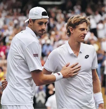  ?? GLYN KIRK/THE ASSOCIATED PRESS ?? American John Isner, left, meets up with Kevin Anderson of South Africa at the net following their epic five-set semifinal match on Friday at Wimbledon. Anderson prevailed in what is now the second-longest match in the history of a tournament that...