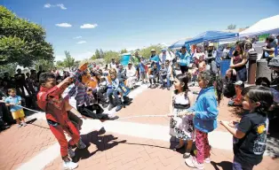  ?? LUIS SÁNCHEZ SATURNO/THE NEW MEXICAN ?? Gibraltar Farrell, front, 10, and David Nieto with Wise Fool New Mexico, do a circus theme puppet show Saturday at the 10th anniversar­y celebratio­n of the Southside Branch Library. The library has become a meeting place for the south side’s diverse...