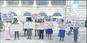 ?? (Photo: Philip Lemonte) ?? Placard-bearing church members of the Tarrant Baptist Church protesting in front of the Montego Bay Cultural Centre in Sam Sharpe Square in the resort city yesterday.