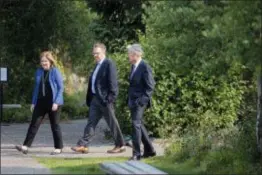  ?? JONATHAN CROSBY — THE ASSOCIATED PRESS ?? Esther George, left, President and CEO of the Federal Reserve Bank of Kansas City, John Williams, center, President and CEO of the Federal Reserve Bank of New York, and Jerome Powell, Chairman of the Board of Governors of the Federal Reserve System, walk together after Powell’s speech at the Jackson Hole Economic Policy Symposium on Friday in Jackson Hole, Wyo. Federal Reserve Chairman Jerome Powell signaled Friday that he expects the Fed to continue gradually raising interest rates if the U.S. economic expansion remains strong.