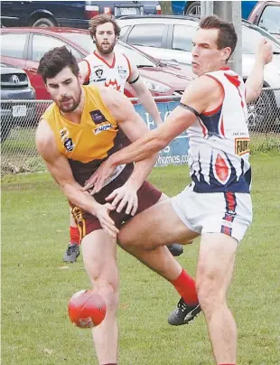  ??  ?? Drouin’s Darcy Irwin and Bairnsdale opponent Shaun Mooney fight to win possession of the ball on Drouin’s half forward line as the Hawks worked their way to a strong home win on Saturday.