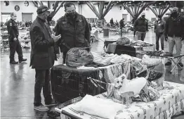  ?? Jon Shapley / Staff file photo ?? Mayor Sylvester Turner, left, and former Police Chief Art Acevedo tour a city warming shelter on Feb. 17 at the George R. Brown Convention Center.