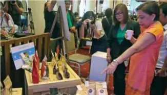  ?? Photo by Milo Brioso ?? BREWING. Senator Cynthia Villar samples locally brewed coffee while taking a look at the coffee beans produced from different parts of the country during the 3rd Philippine Coffee Conference.