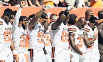  ?? AP ?? Cleveland Browns players raise their fists during the national anthem before an NFL football game against the Cincinnati Bengals on Sunday, October 1, in Cleveland.