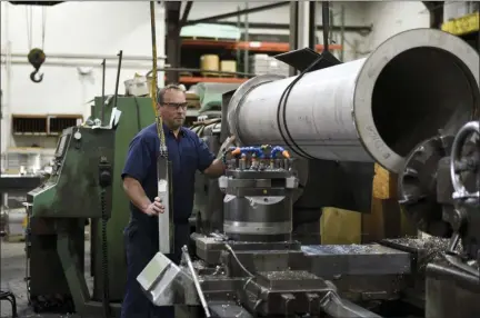  ?? LAUREN A. LITTLE — MEDIANEWS GROUP ?? Mike Graham, machinist, moves a part onto a machine at R-V Industries Inc. in Honey Brook, Chester County. The company recently purchased a 44,000-square-foot building that officials say will allow R-V Industries to expand.