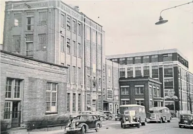  ?? LYNN BEBENEK ?? Reader Lynn Bebenek submitted this early 1950s photo featuring the brewery complex and two Blue Top trucks at the curb. Her father, Robert Tolmie, worked there in the early 1950s, then transferre­d to Dow in Toronto after the sale. Behind the huge Blue Top sign at right is Kaufman Rubber Company, now Kaufman Lofts.