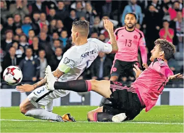  ??  ?? One-way ticket: Slovakia captain Martin Skrtel diverts the ball into his own net for the only goal on Thursday to give Scotland victory