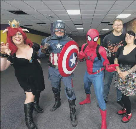  ??  ?? WELCOME Superhero cosplayers with co-owners Max Cooke and Beth Davis, third right and second right, respective­ly