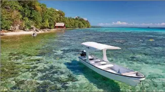  ??  ?? The azure waters at Fatboys Resort were sparkling clear and offered great snorkeling with lots of coral and colorful fish.