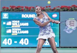  ??  ?? Venus Williams hits a backhand against Serena Williams.